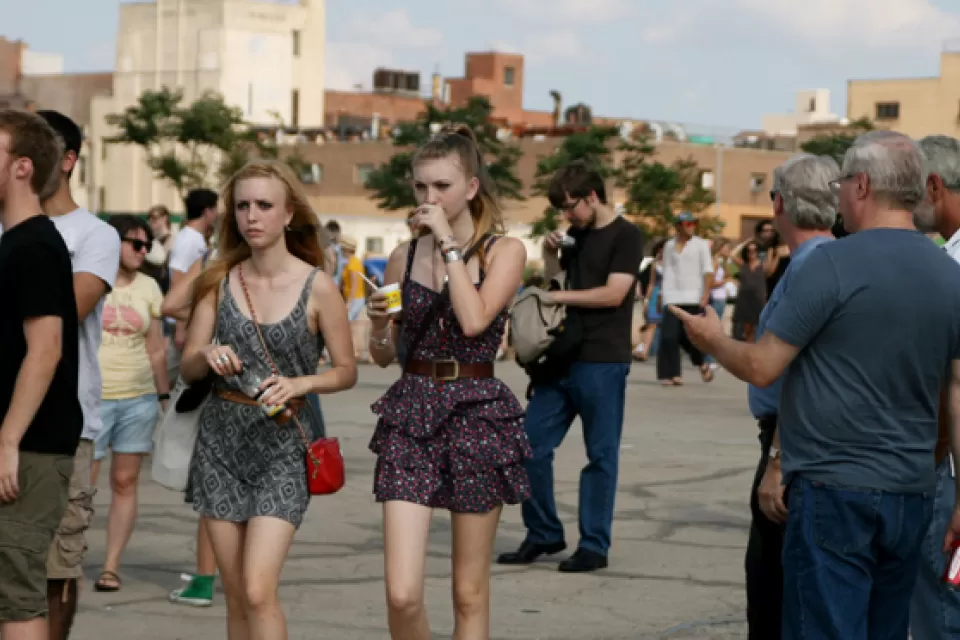 Young and all people stroll at a community event in New York City.